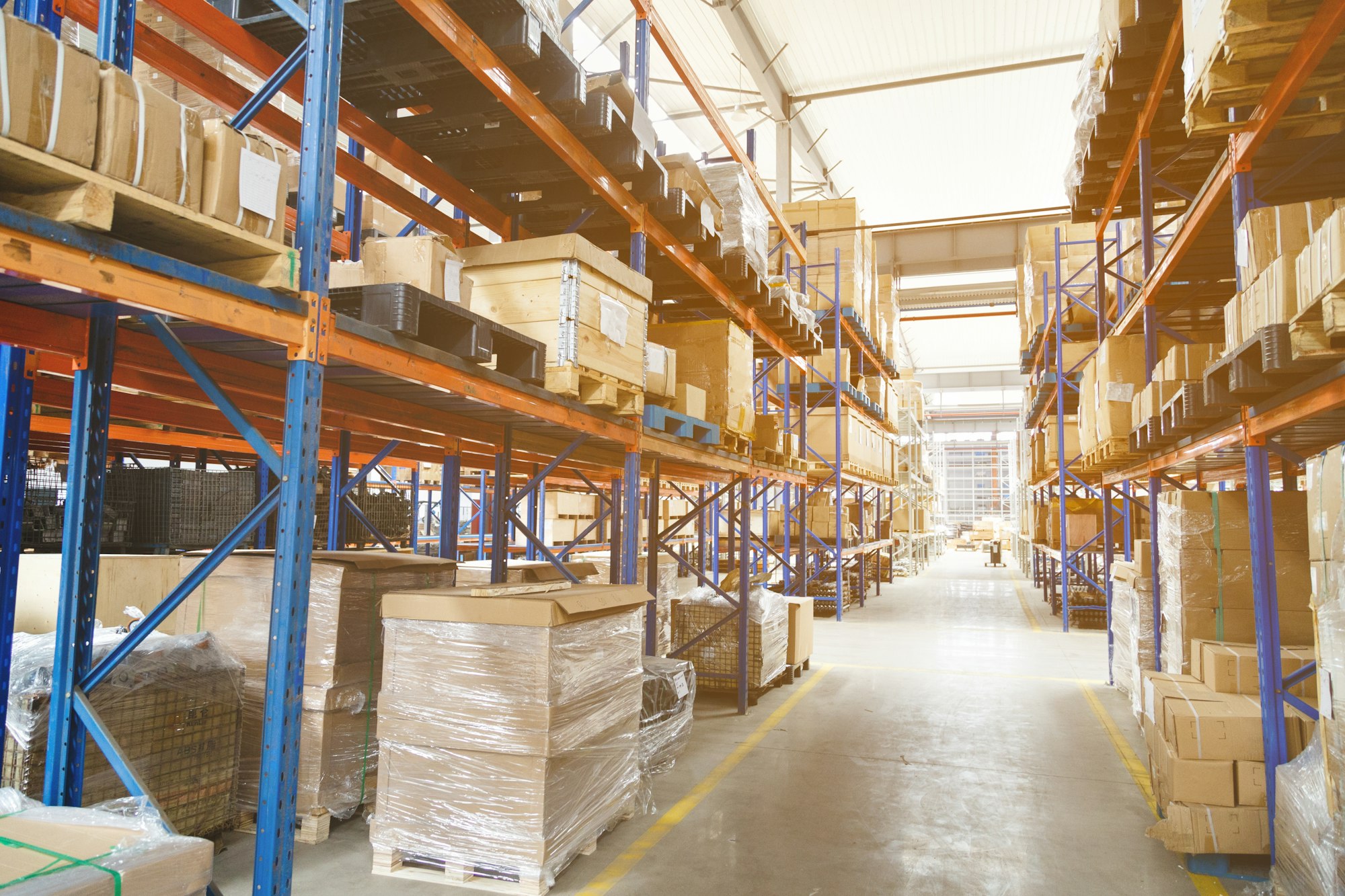 Modern warehouse with shelves of goods. Industrial storehouse with boxes and copy space